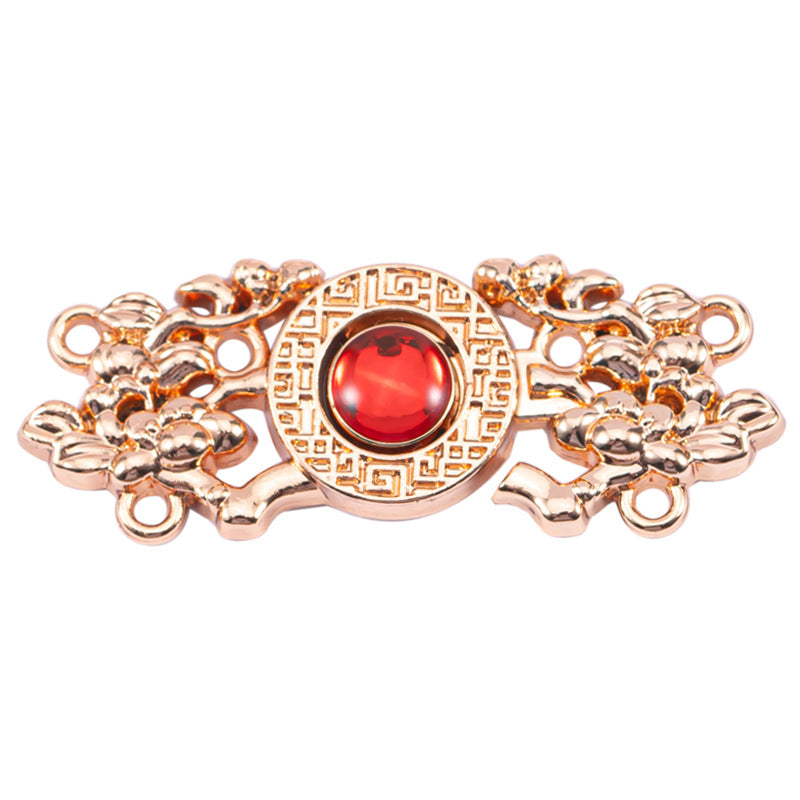 Copper Chinese knot metal button with red cat’s-eye stone, detailed gold-toned filigree