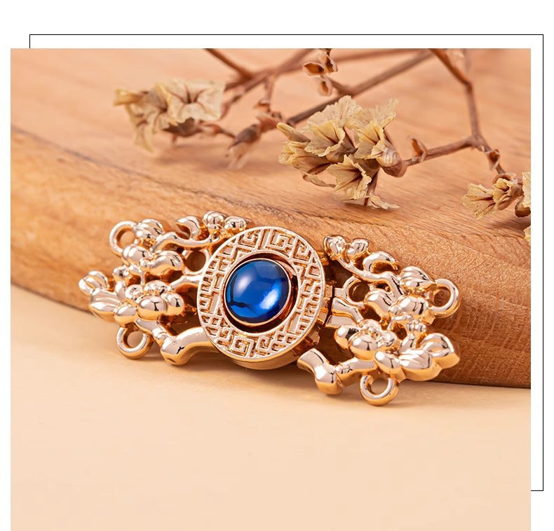 Copper Chinese knot metal button with blue cat’s-eye stone, decorative chain filigree