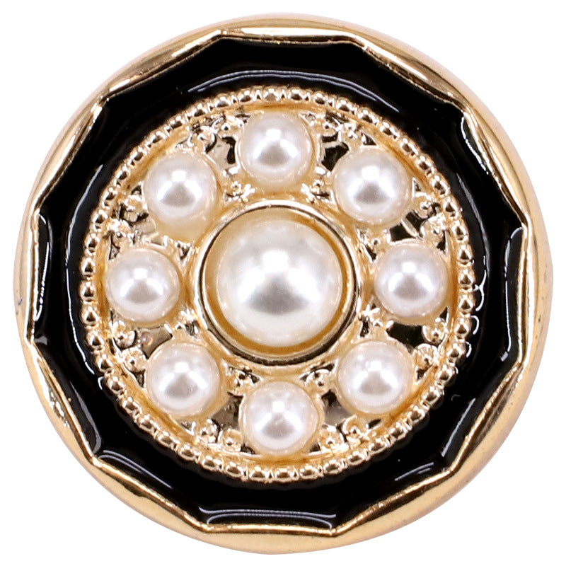 Close-up round shank button with black backing, gold filigree, and multiple pearl beads