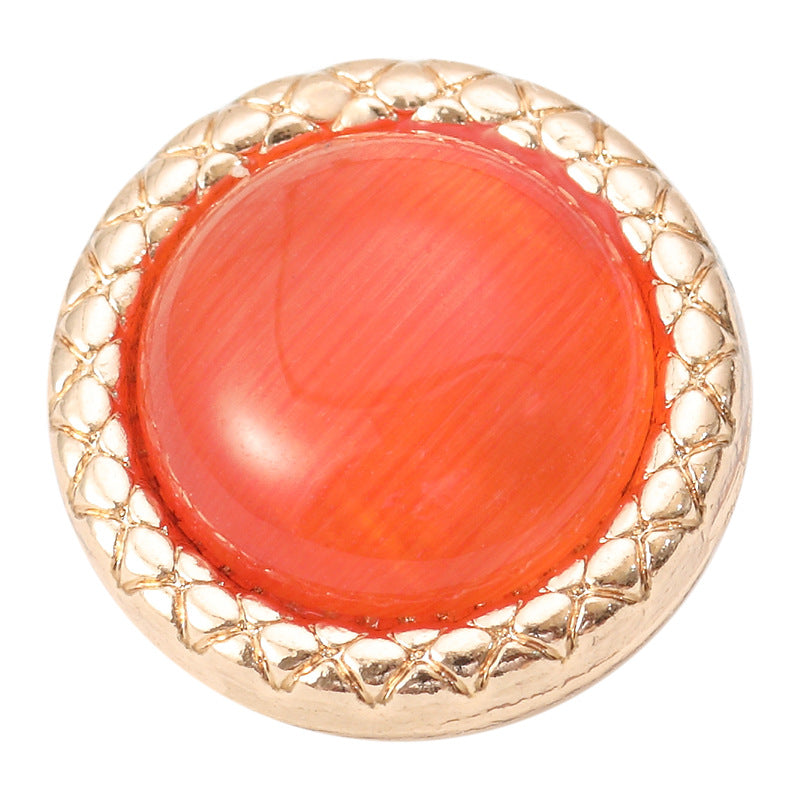 Einzelner runder Resin-Knopf mit Goldfarbenem Metallrand, leuchtend orange