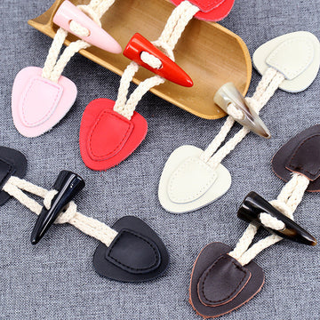 Horn toggle buttons set in pink, red, beige, and dark brown leather patches, 5 pcs