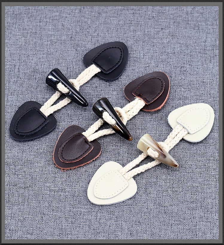 Assorted horn toggle buttons: black, dark brown, and cream leather patches, 5 pcs