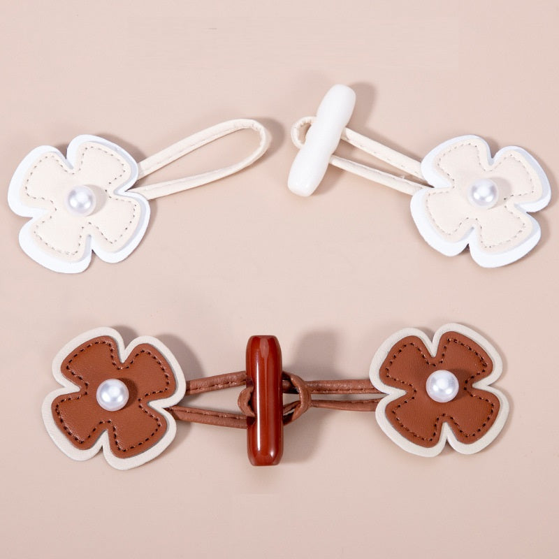 Pair of brown faux leather flower toggle buttons with faux pearls and matching straps