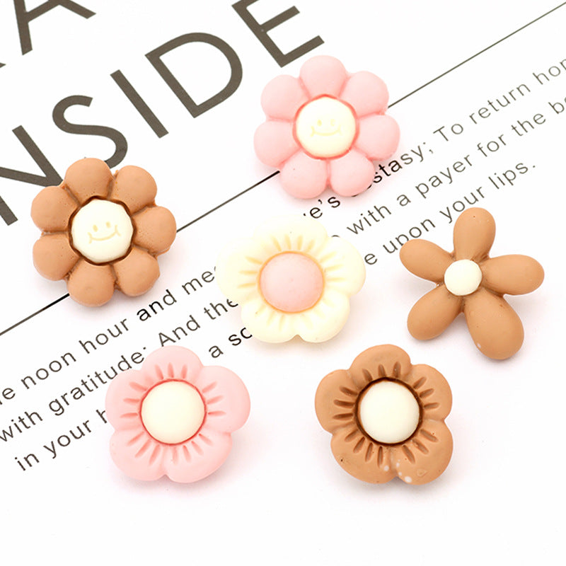 Flower resin buttons with cute faces on centers, pink, white, yellow, and brown