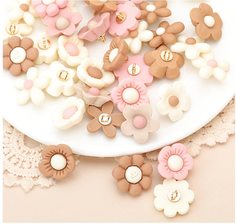 Assorted flower resin buttons in white, cream, pink, and tan with gold-tone centers