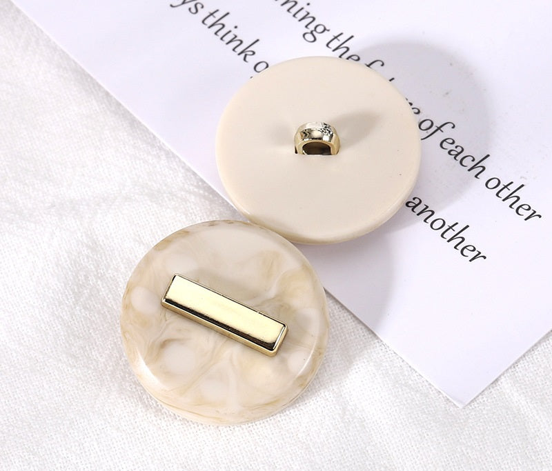 Beige round resin buttons: gold-tone loop shank and rectangular front detail