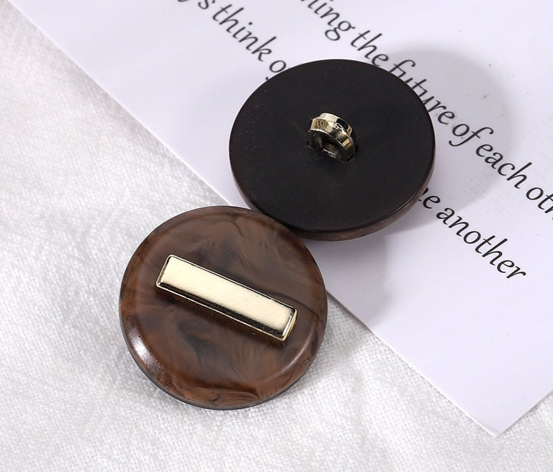 Coffee brown round resin button with gold-tone rectangular front and loop shank