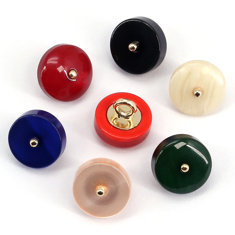 Assorted round resin buttons: red, black, blue, green, cream, pink, each with metal shank