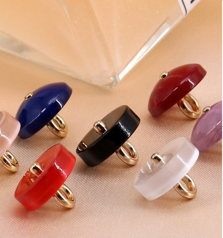 Assorted round resin buttons with metal shanks in red, blue, black, white—gold-tone posts
