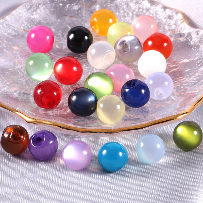Assorted round resin pearl buttons in tray, glossy colors including red, blue, pink, green
