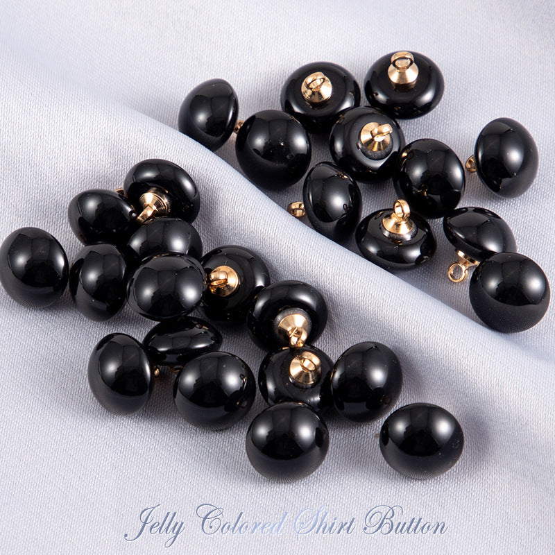 Black jelly resin round shirt buttons with gold-tone shanks, glossy finish