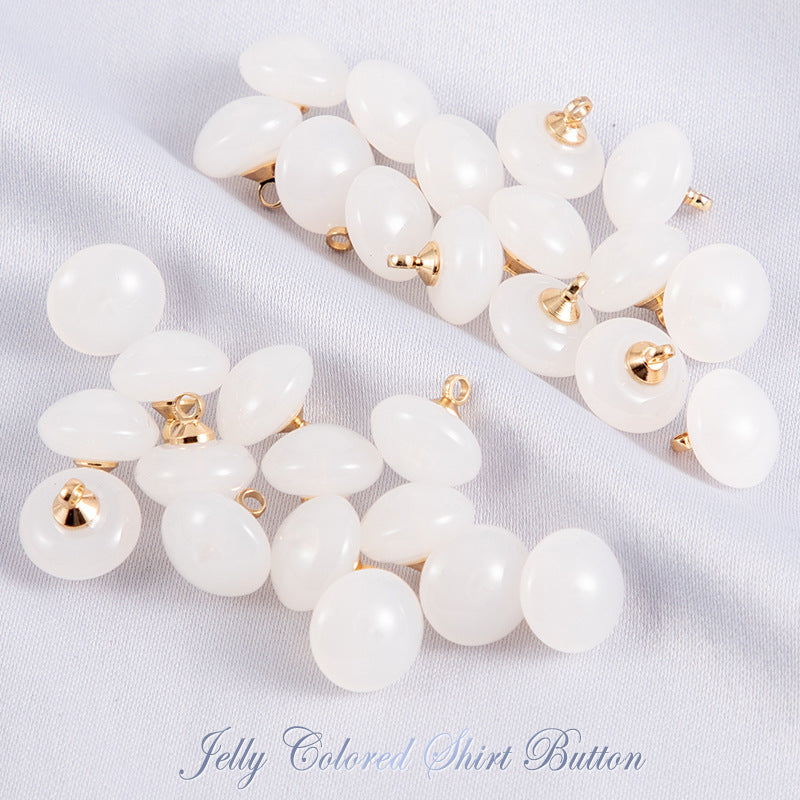 White jelly resin round shirt buttons with gold-tone shanks, glossy finish