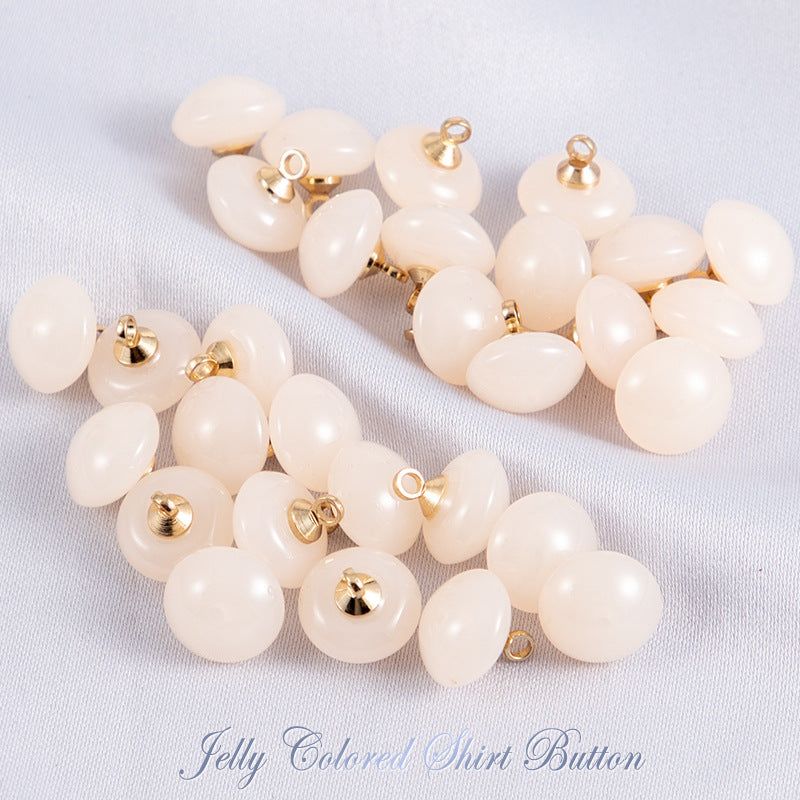 Cream/beige jelly resin round shirt buttons with gold-tone shanks, glossy finish