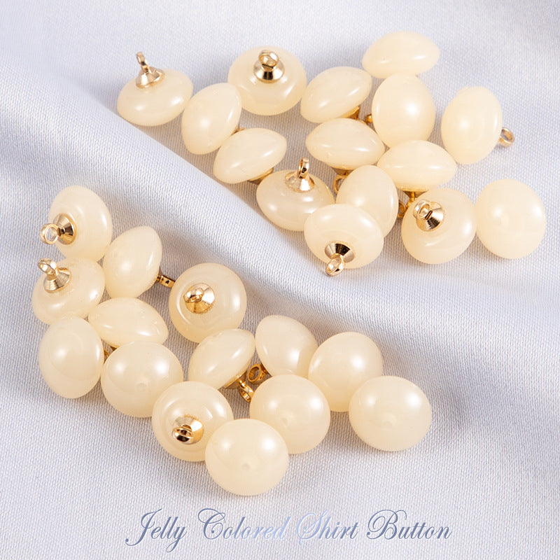 Light cream jelly resin round shirt buttons with gold-tone shanks, glossy finish