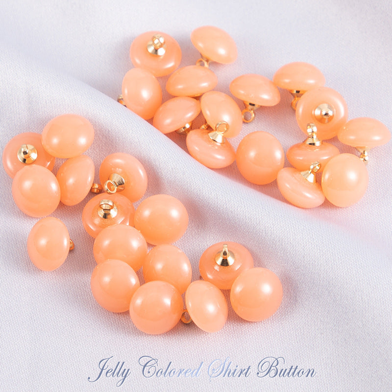 Orange jelly resin round shirt buttons with gold-tone shanks, glossy finish