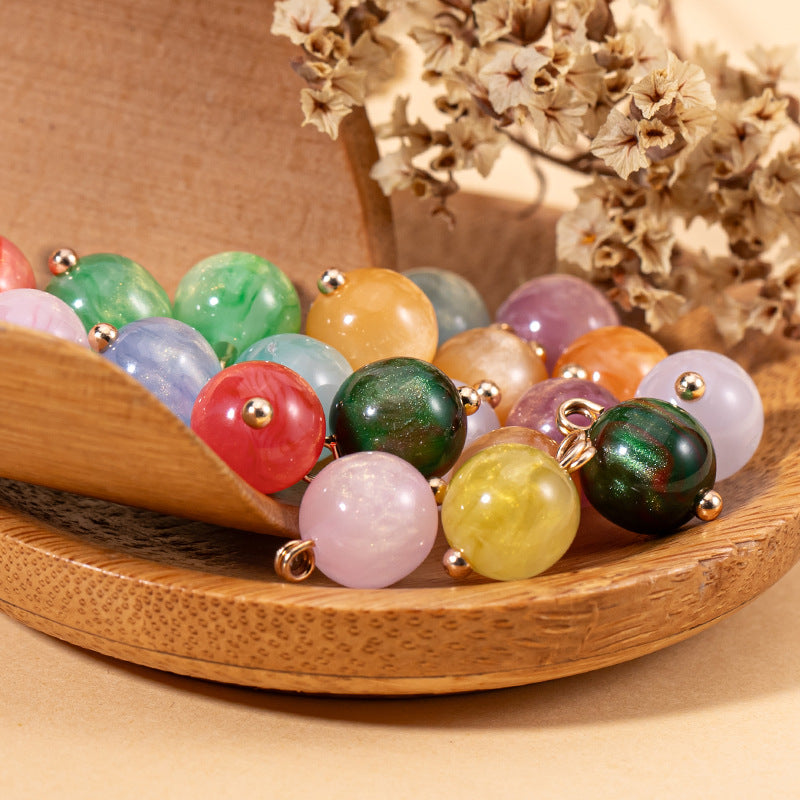 Colorful round resin bead buttons with gold-tone loops and domed pearlescent finish