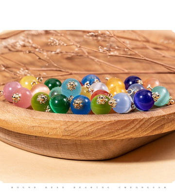 Round cat’s eye stone bead buttons, mixed colors with gold-tone mounts