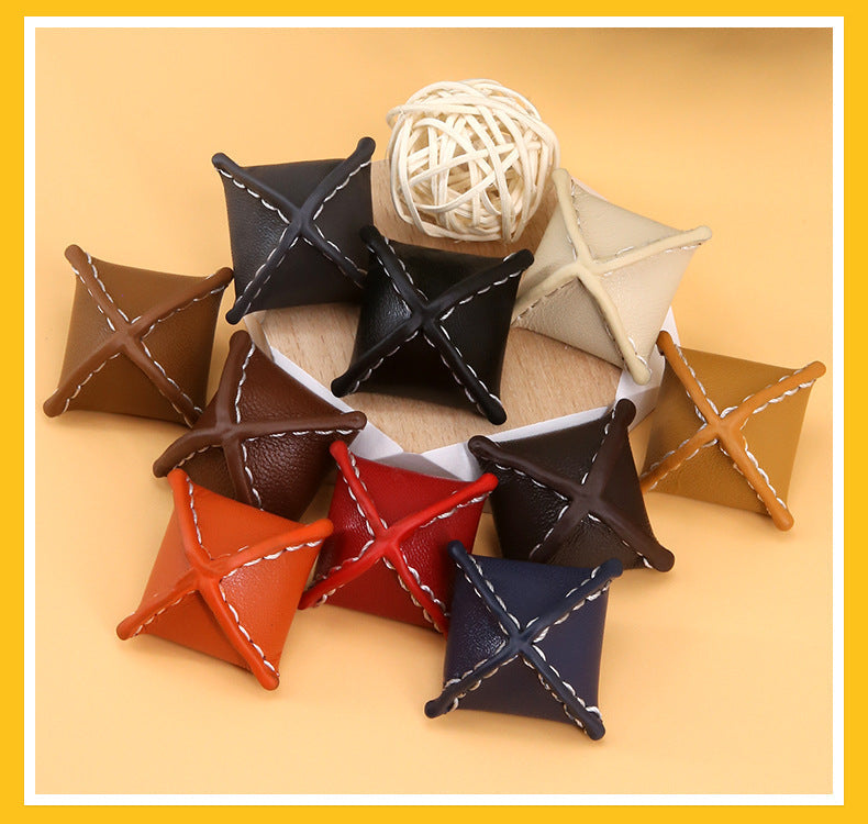 Assorted rhombus leather coat buttons with stitched X fronts and loop shanks