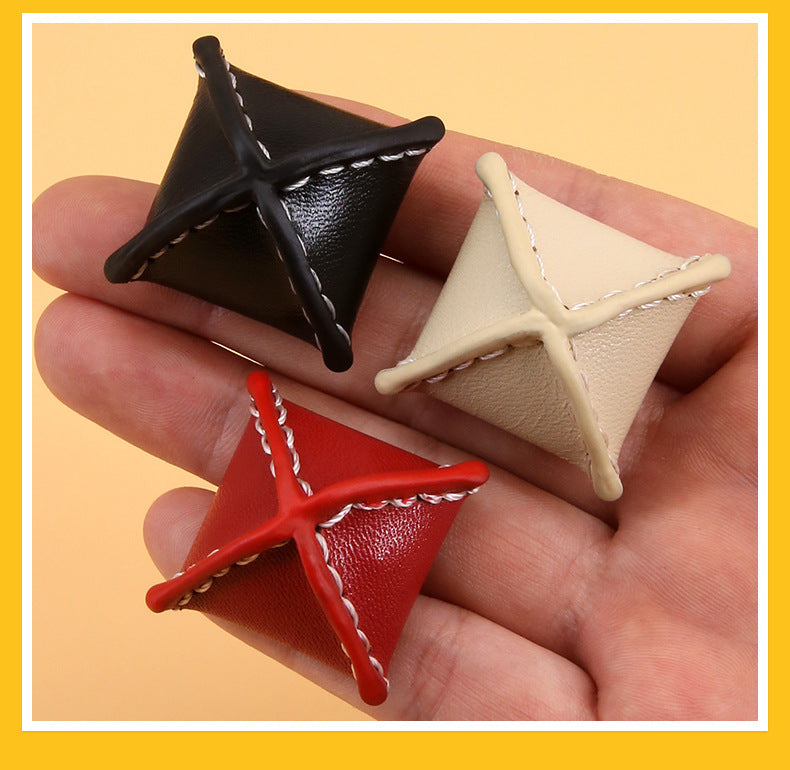 Black and cream rhombus leather buttons with stitched X and loop shank