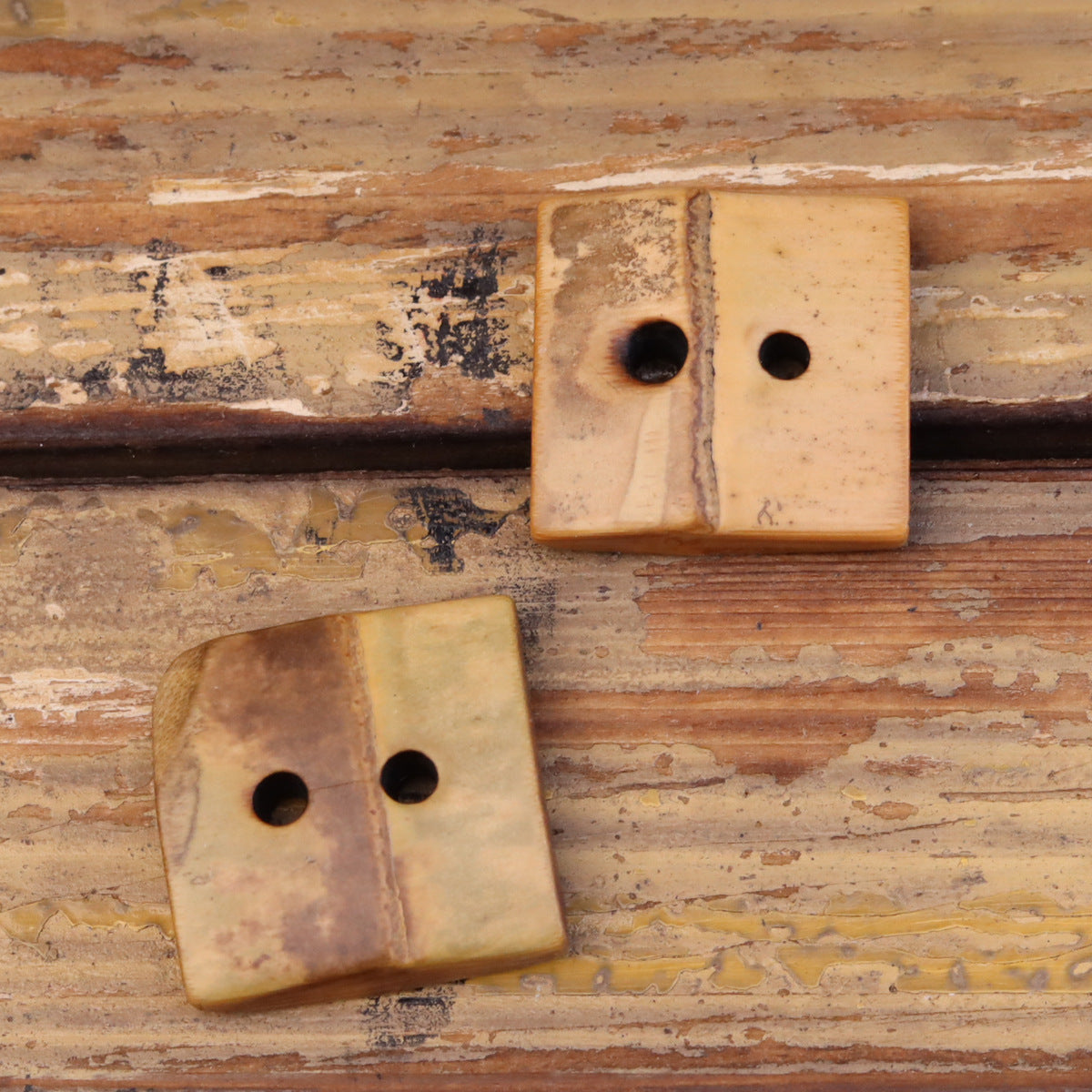 Square two-hole bamboo buttons, natural bamboo grain, one button on top