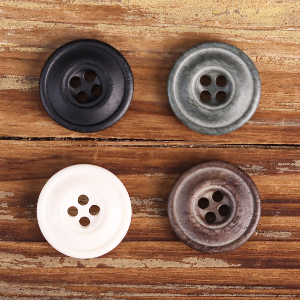 Assorted distressed 4-hole buttons in black, gray-green, white, and coffee