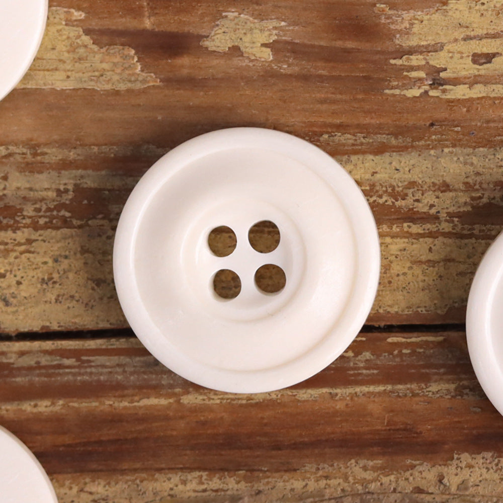 White 4-hole distressed button with worn, retro finish