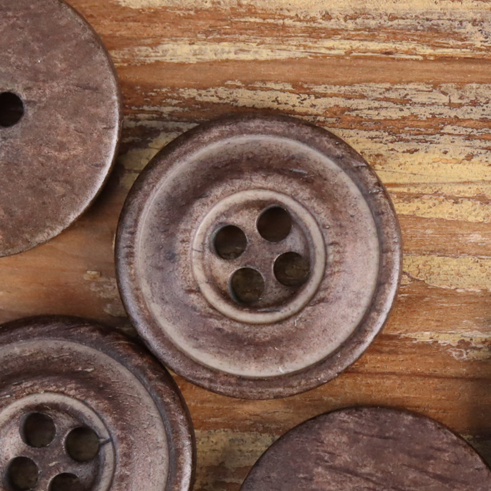 Gray-brown distressed 4-hole button, round with worn rim