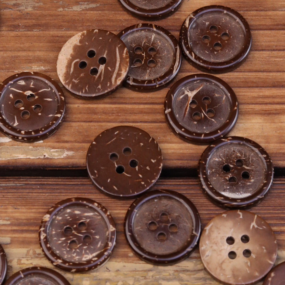 Assorted dark brown coconut shell buttons, round 4-hole styles with visible shell texture