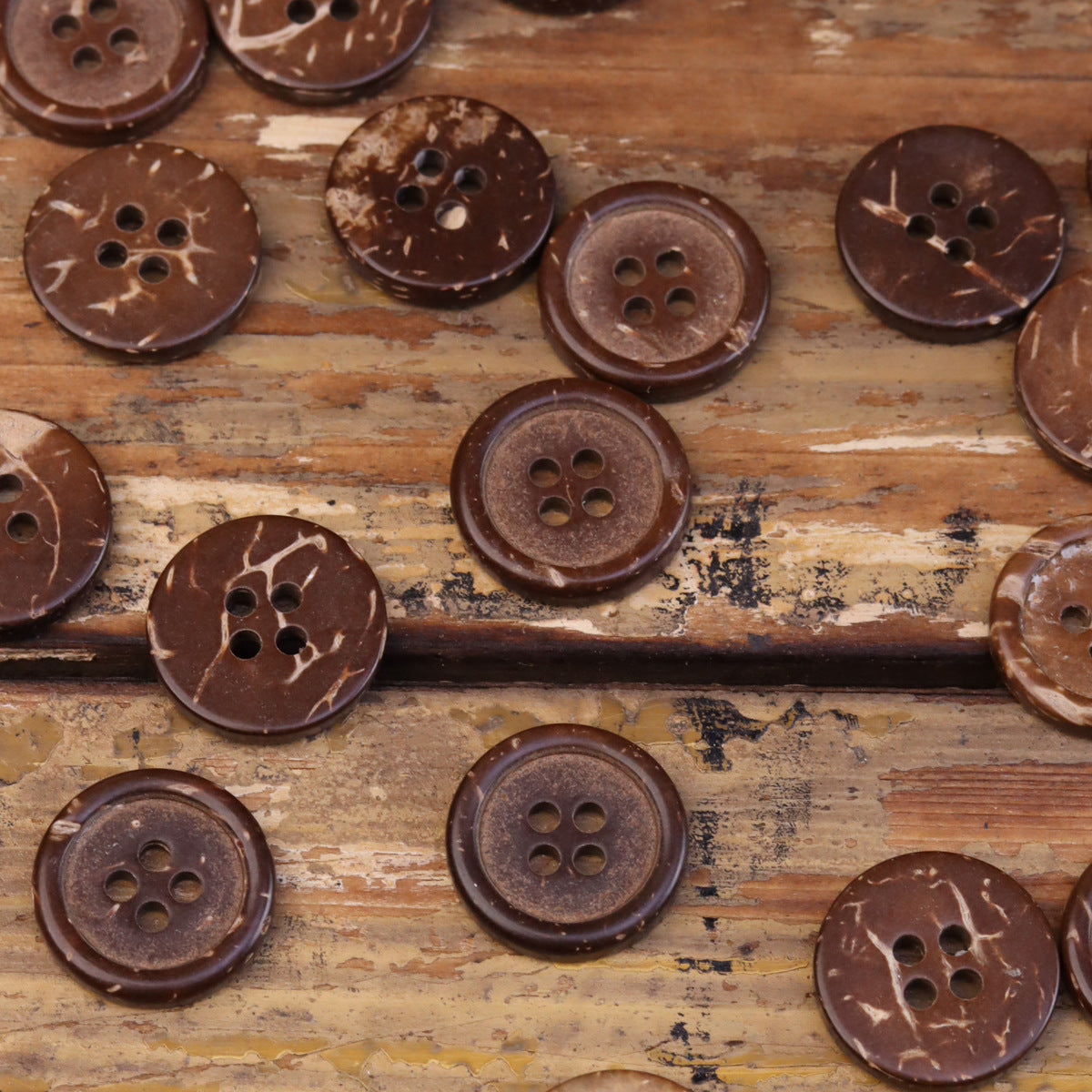 Set of dark brown coconut shell buttons with round 4-hole centers, varied natural patterns
