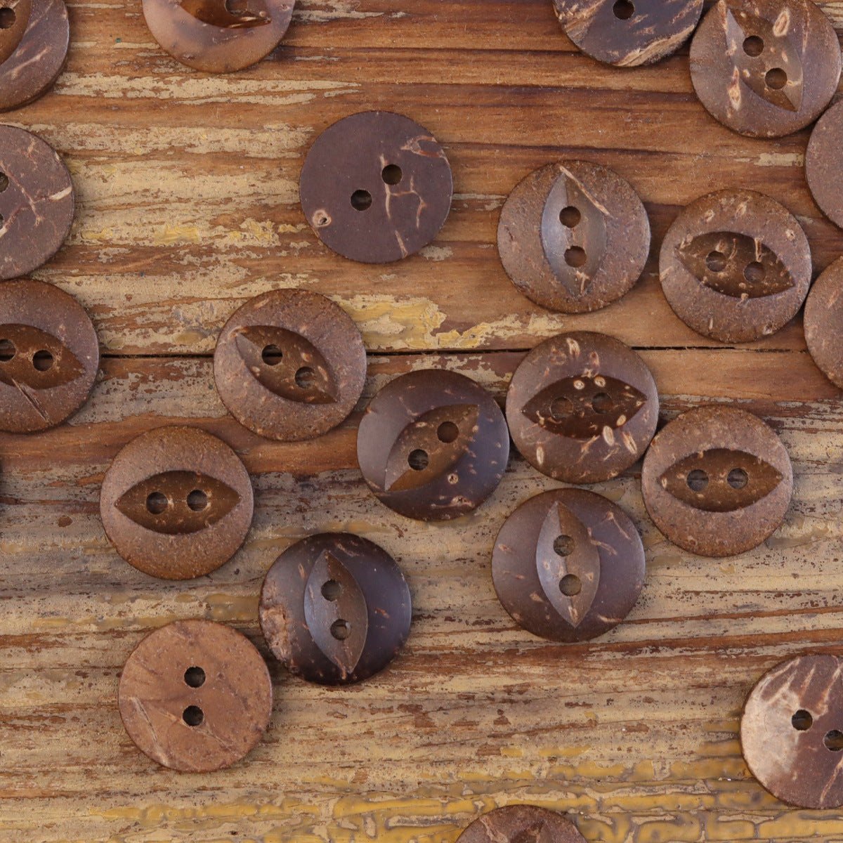 Set of dark coffee fish-eye coconut shell buttons with two holes each.