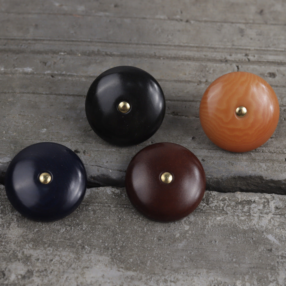 Natural palm nut shank buttons, set in black, dark blue, dark brown, and orange.