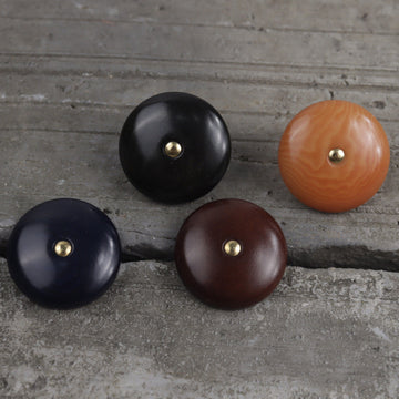 Natural palm nut shank buttons, set in black, dark blue, dark brown, and orange.