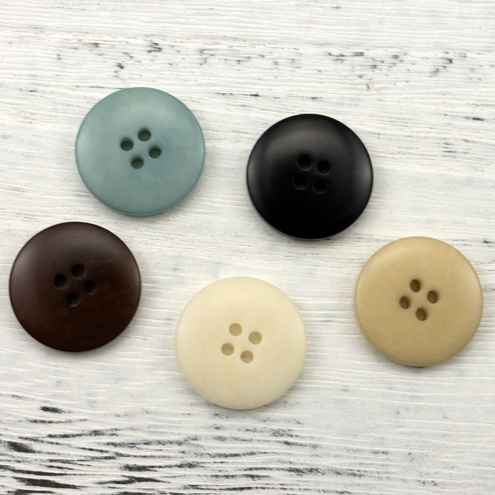 Round four-hole buttons in gray-blue, black, dark brown, cream, and light tan
