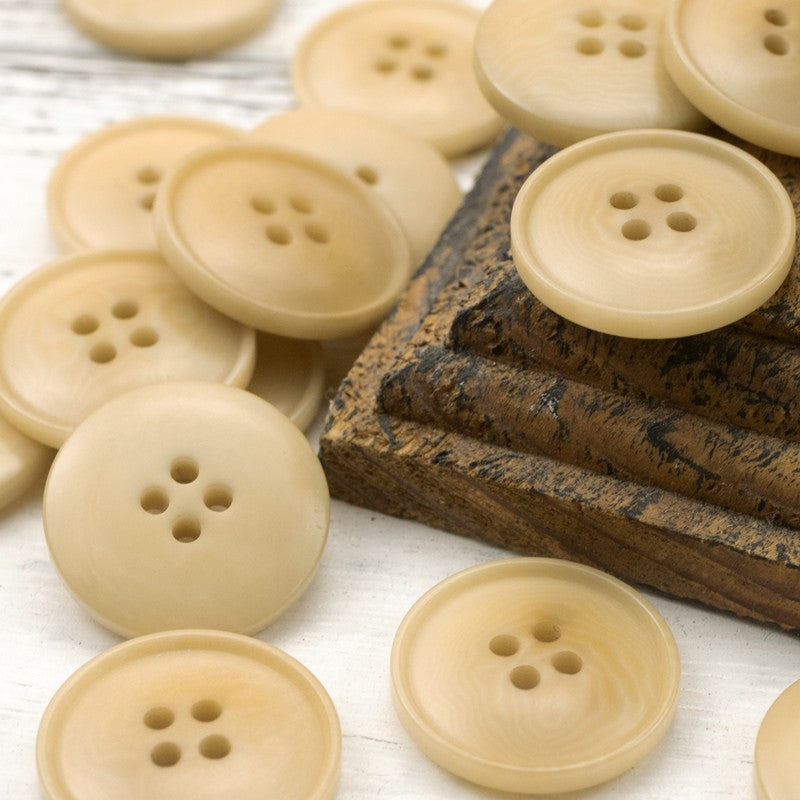 Light tan round four-hole palm nut buttons, multiple buttons with four holes