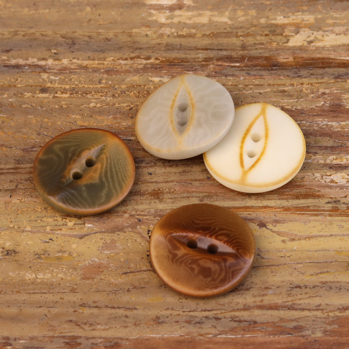 Palm nut shell buttons in white, tan, and dark brown, some with 2 holes
