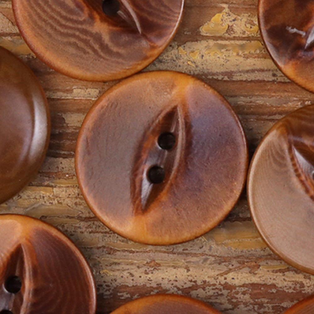 Brown palm nut shell button with dark inlay, textured surface, 2 holes