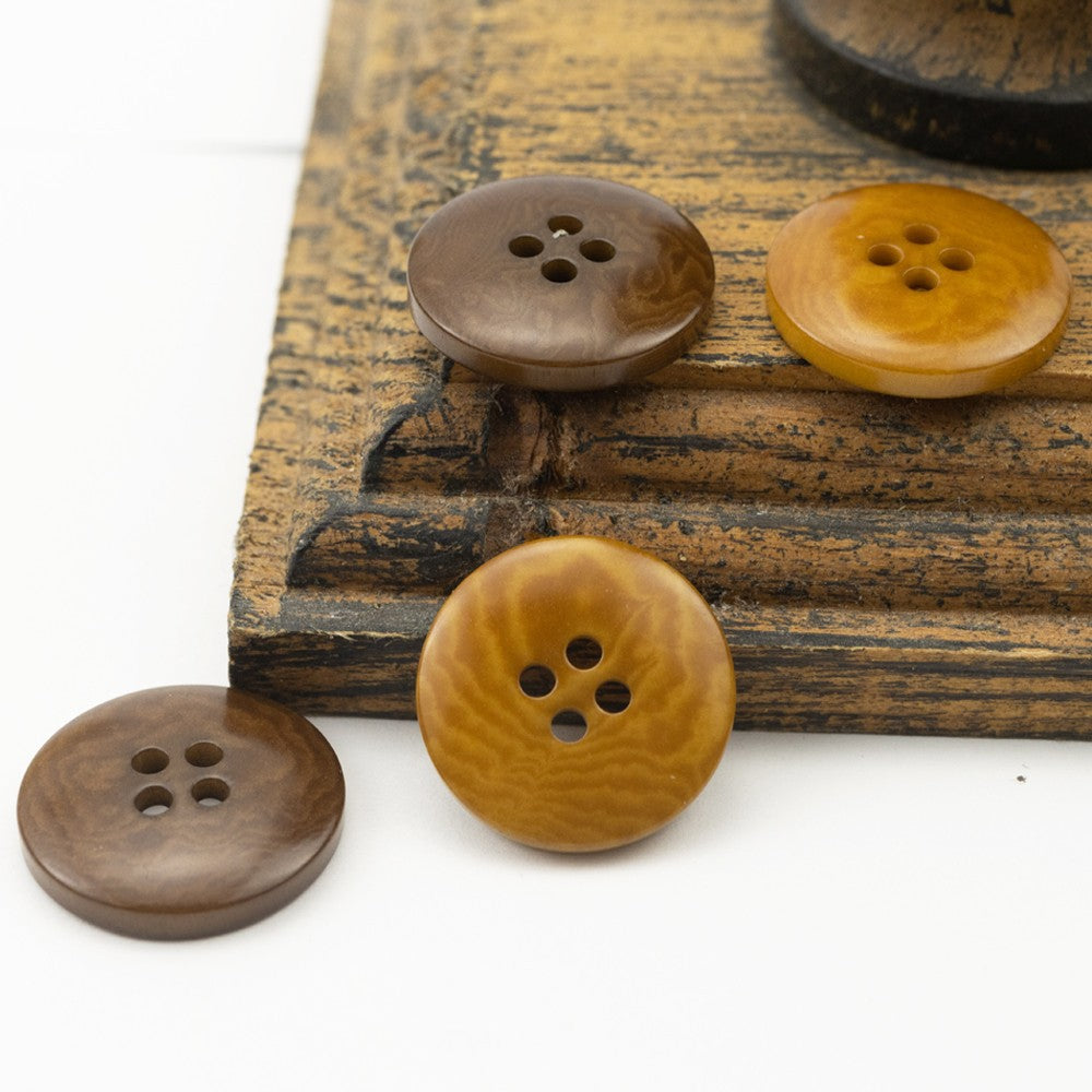 Assorted four-hole nut shell buttons in yellow and dark brown