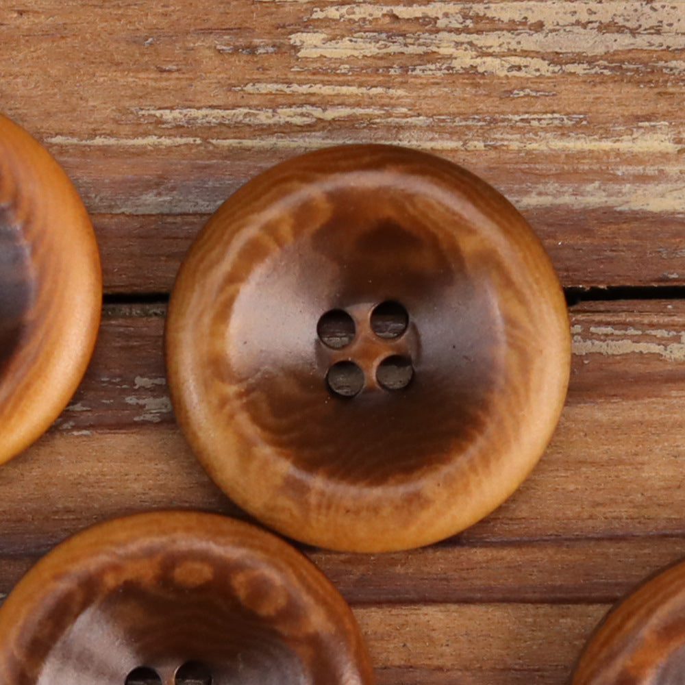 Close-up of brown retro burnished nut shell button with 4-hole shank