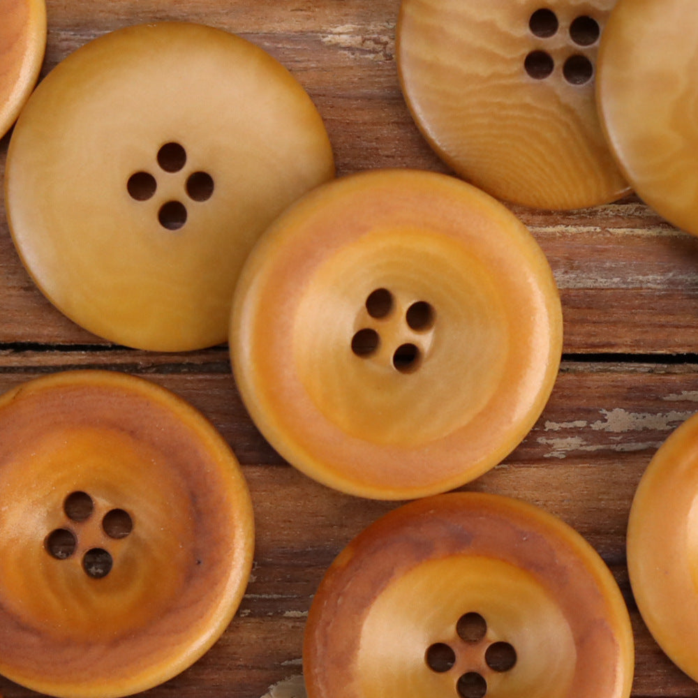 Assorted amber and orange nut shell buttons with 4-hole centers, round 15–25mm