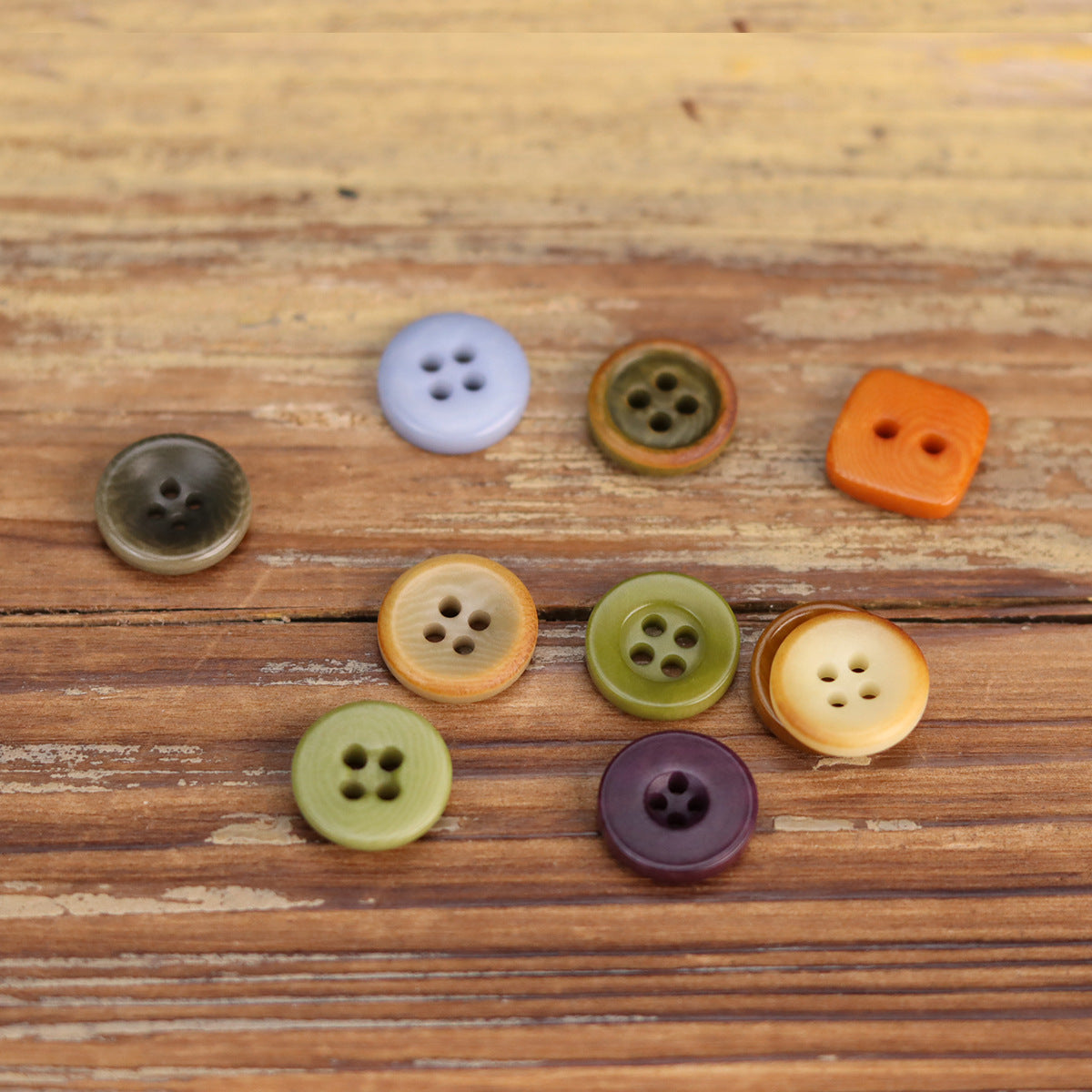 Assorted 11.5mm shirt buttons in light purple, bronze, orange and green, four-hole