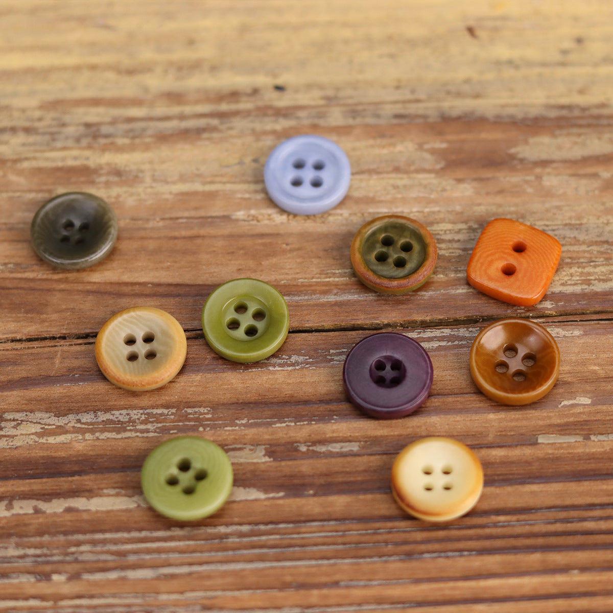 Assorted 11.5mm shirt buttons in grey, olive, orange, purple and cream, four-hole