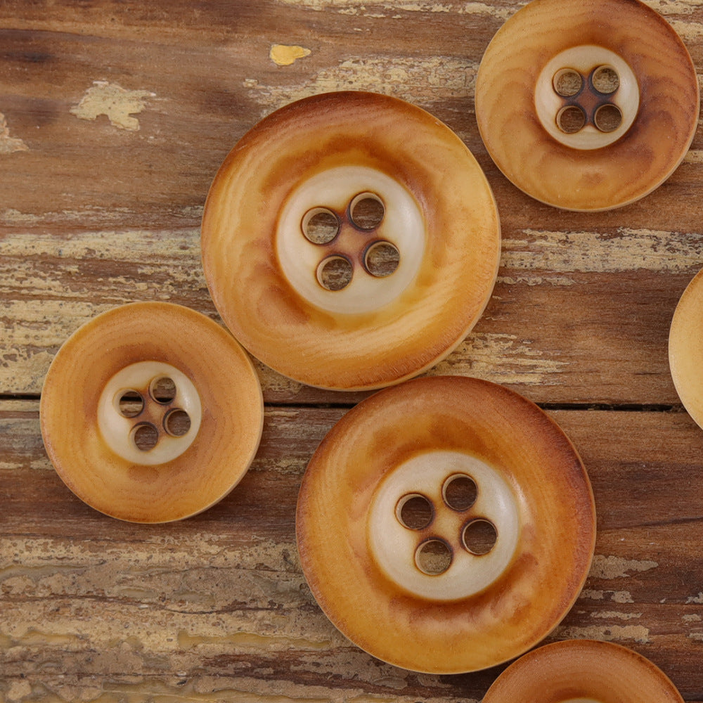 Thickened nut buttons in warm amber/caramel tones, four-hole fronts