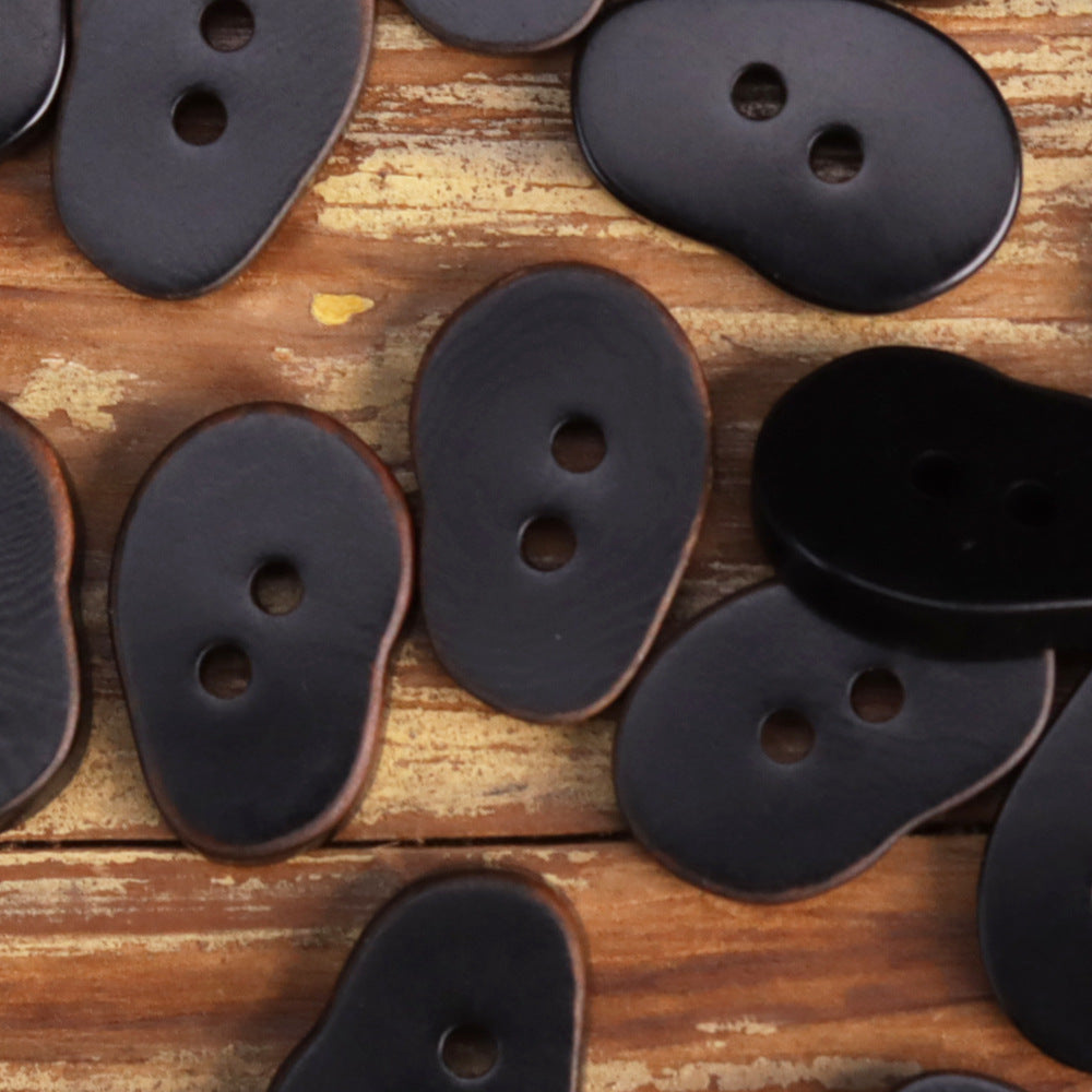 Dark navy/black peanut-shaped buttons with two holes each