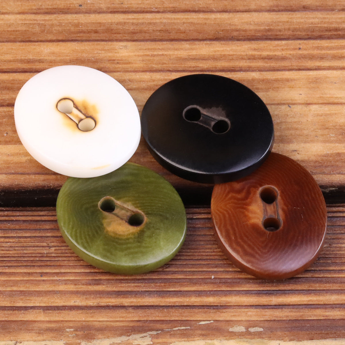 Oval 2-eye natural fruit buttons with loop backs: white, black, olive green, brown