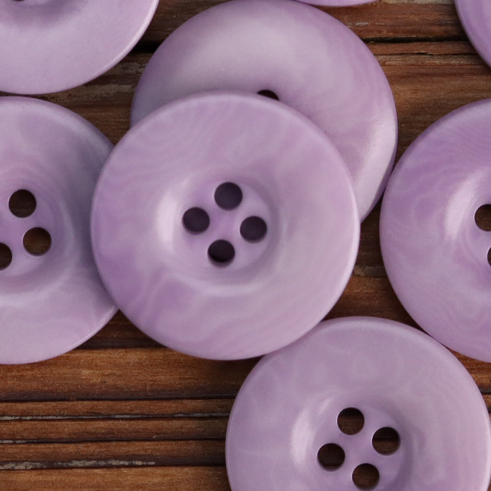 Close-up lilac purple 4-hole corozo button face with four stitched holes