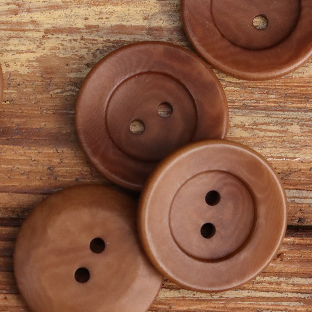 Two-hole corozo buttons: reddish-brown and tan, round bowl-shaped with two holes