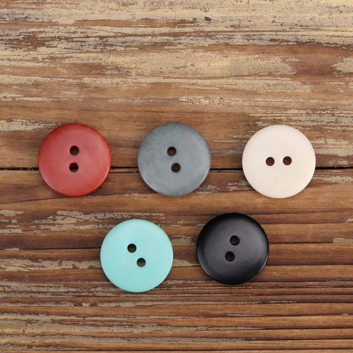 Assorted irregular corozo 2-hole buttons in sky blue, red, gray, white, black