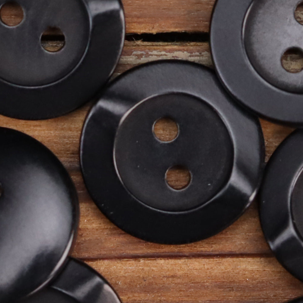 Black irregular corozo 2-hole buttons, visible front and holes