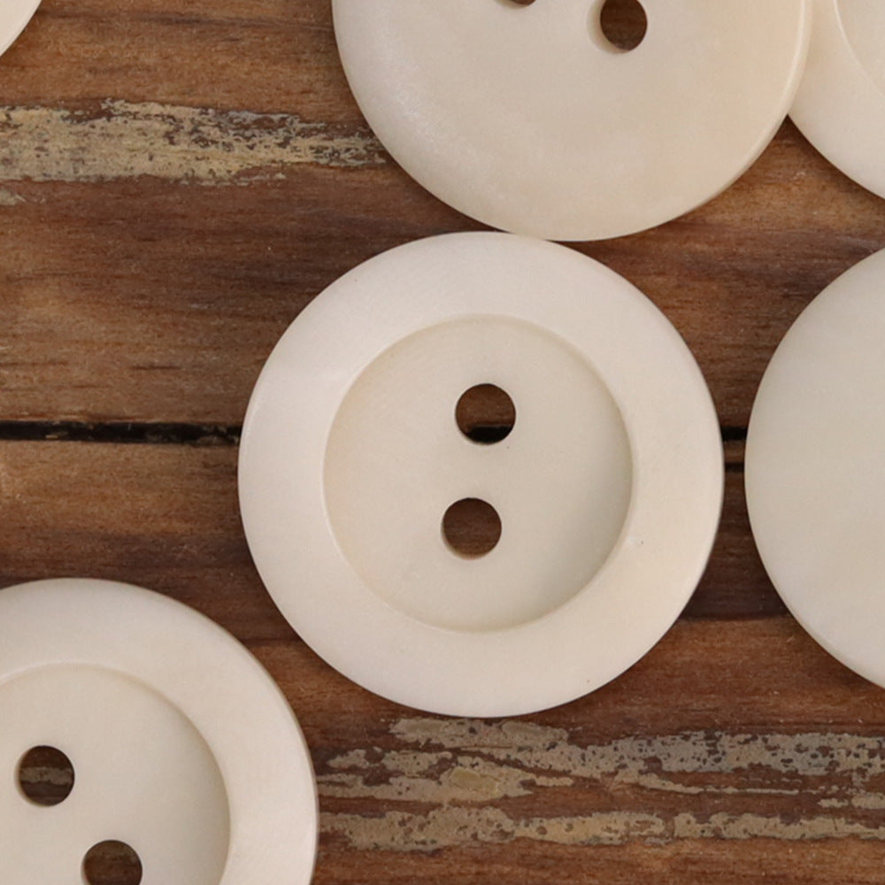 White irregular corozo 2-hole buttons with smooth front face
