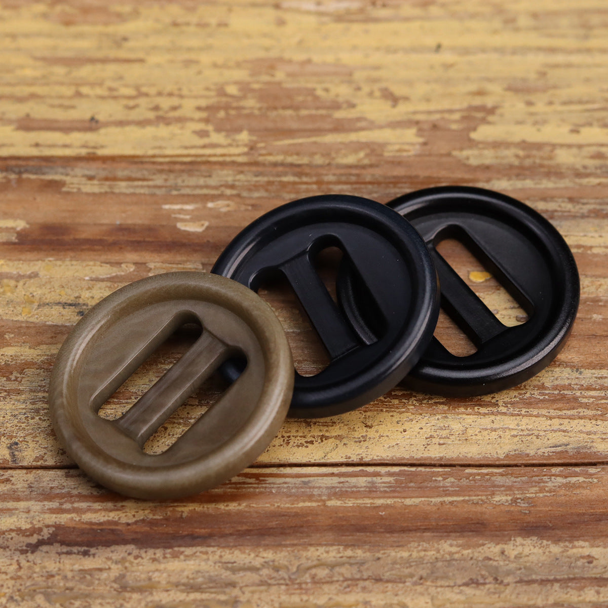 Oblong-hole corozo-style buttons, khaki and black, round with two inner slots